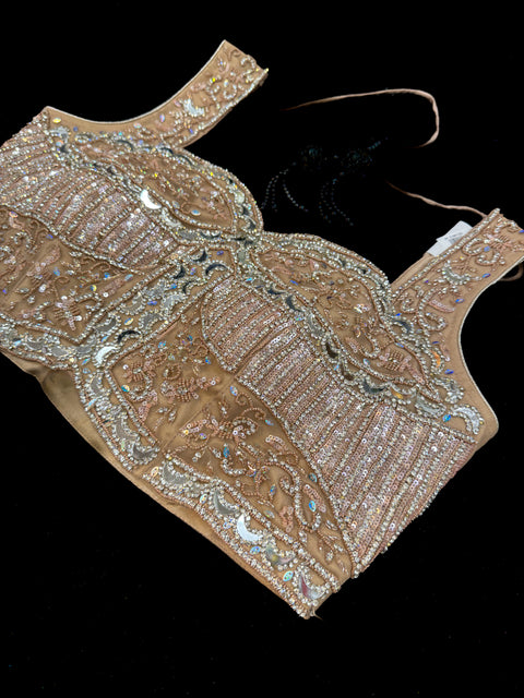 Netting based stones with mirror work designer blouse with shimmery netting heavy flared lehnga and netting based sequined work dupatta