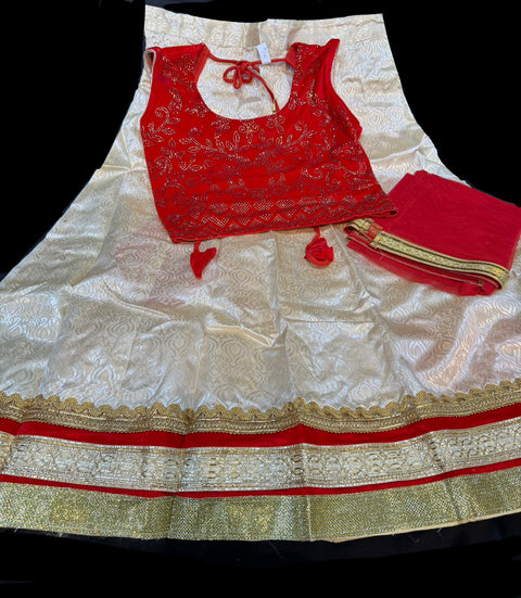 velvet based stone work blouse with golden with pink and red shades on raw silk based lehnga