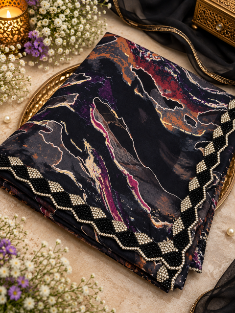 Elegant Printed Saree featuring a rich abstract print with a statement embellished border detailed with pearl and stone work.Blouse worn by the model is for reference only.blouse piece is attached with saree.Slight variation in colour & design may occur