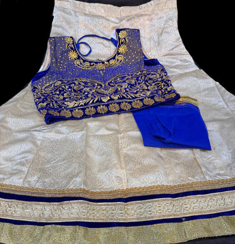 Royal blue colour velvet based blouse with embroidery & Stone work with golden brocade silk Lehnga & netting dupatta