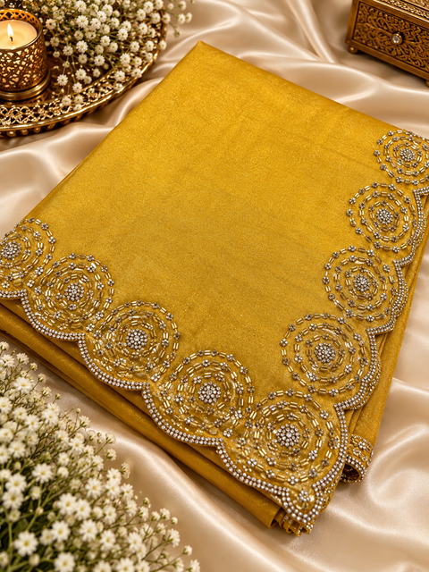 Two-Tone Tissue Silk Saree with a beautiful gold sheen and elegant handcrafted border detailing. Comes with an attached blouse piece; blouse worn by the model is for reference only. Slight variation in colour and design is possible.