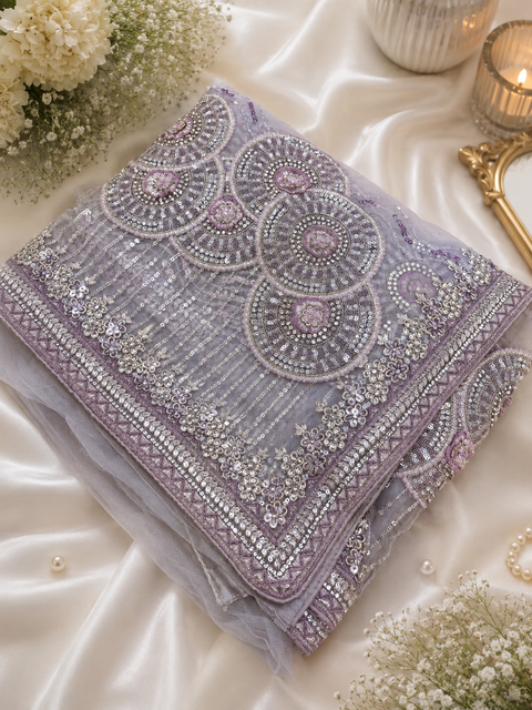 Heavy work designer Saree with netting base fabric and stones work design all over with heavy embroidery .The Blouse Worn By The Model Is For Reference Purposes Only. The Actual Blouse Piece Comes Attached With Saree(Slight Variations Are Possible)
