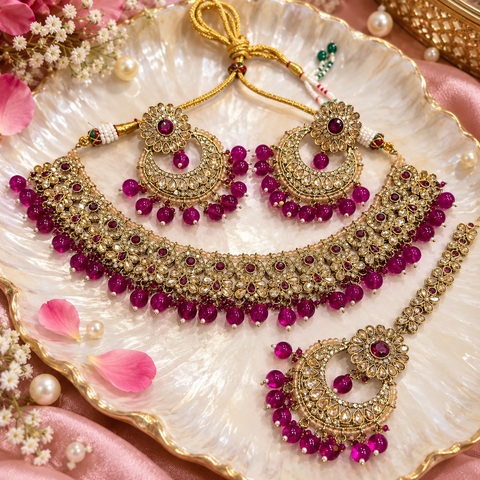 Beautiful polki stones with pearls and colorful stones necklace & earrings with Tikka. Slight variations in colour and design are possible