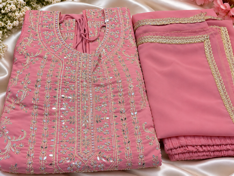 Beautiful georgette fabric outfit with full embroidery and mirror work all over the kameez. Paired with a loose circular palazzo and a matching dupatta with just a border. 
Slight variation in colour and design is possible