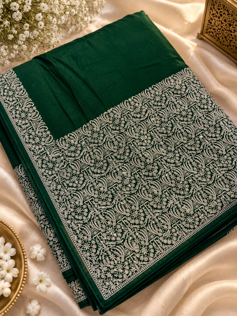 Soft-flowing fancy silk georgette saree with elegant embroidered borders, fine stone work and a heavy detailed pallu. Includes an attached embroidered blouse piece; model blouse is for reference only. Slight variation in colour/design possible.