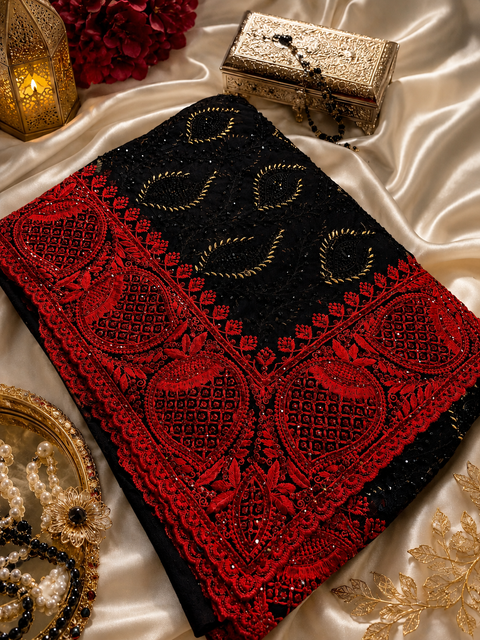 Elegant black net saree with all-over black stone work and a striking red embroidered border with red stones, crafted for luxurious & unforgettable party look,Blouse Piece is For Reference Only, Blouse Piece Attached to Saree(slight variation is possible)
