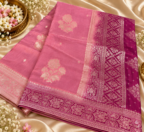 Dola Silk Saree with elegant all-over floral zari weaving and a rich contrasting woven border with detailed pallu. Soft, graceful drape with a luxurious festive look. Contrast blouse piece included.Slight variation in colour and design is possible.