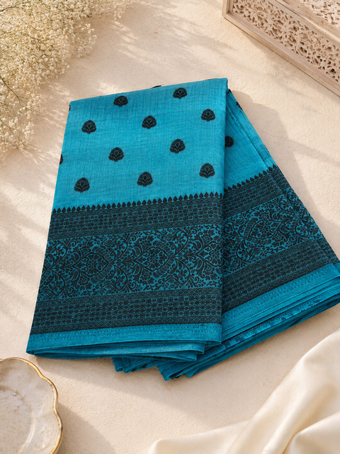 Beautiful semi-silk cotton saree with an elegant woven border and classic motifs. Attached blouse piece included. Slight variation in colour and design may occur.