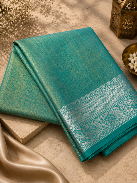 Soft Silk Tissue Saree with Dual Tone Metallic Finish .Model-worn blouse is for reference only. Unstitched blouse piece is attached with saree(slight variation in color & design is possible)