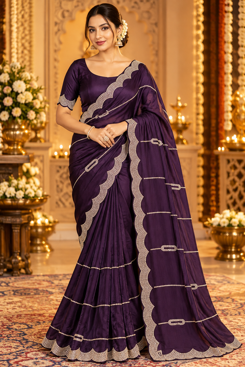 Soft Shiny Georgette Saree with a beautiful flowy drape, elegant stonework lines and a rich scalloped stone border. Attached blouse piece included; model blouse is for reference only. Slight variation in colour and design is possible.