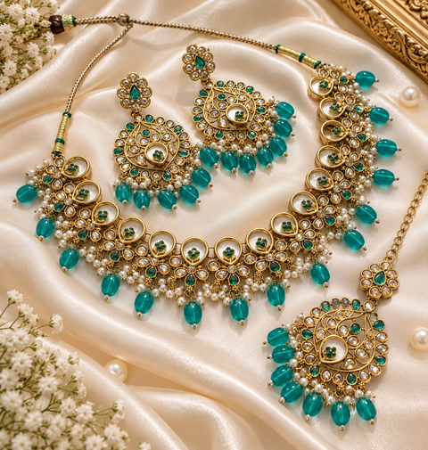 Beautiful polki stones with pearls and colorful stones necklace & earrings with Tikka. Slight variations in colour and design are possible (ll