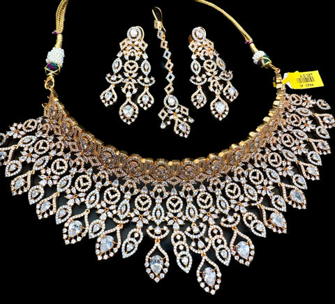 (video clip attached )Golden color Beautiful and elegant look Bridal/Semi Bridal American diamonds studded Heavy work necklace with beautiful earrings Note :- original AD stones  not fake plastic stones )
