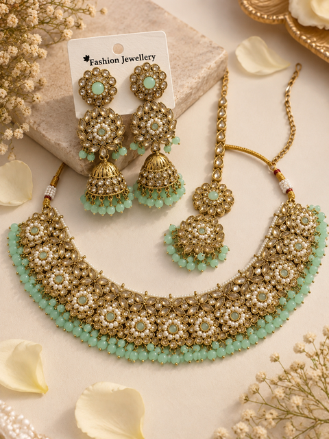 Beautifully crafted with sparkling golden stones, Polki-look stones, and colourful beads. Slight variations in colour and design are possible.