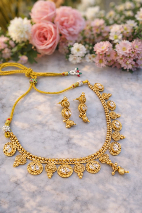 Elegant traditional gold necklace set featuring intricate detailing and delicate stone accents, perfect for adding timeless charm to any festive look