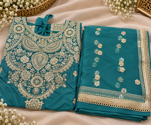 Elegant Chanderi Silk suit featuring all-over heavy embroidery and mirror work with a beautifully detailed neckline. Paired with a heavily embroidered palazzo and a gorgeous matching dupatta .Slight variation may ofcolour & design is possible