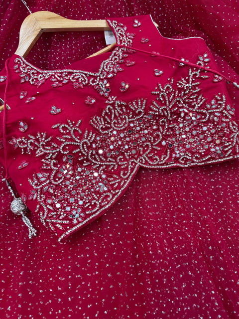 Netting based stones with mirror work designer blouse with shimmery netting heavy flared lehnga and netting based sequined work dupatta