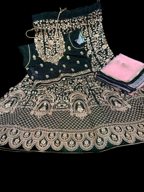 Deep Green colour velvet based heavy embroidery lehnga with pink colour netting embroidered dupatta