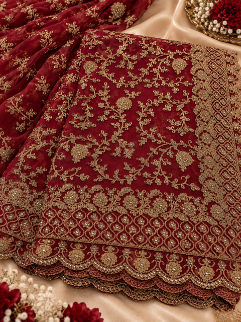 Elegant net saree featuring intricate all-over embroidery with beautiful stone work and a richly detailed border.Comes with an attached blouse piece,the blouse worn by the model is for reference only. Slight variation in colour & design may occur