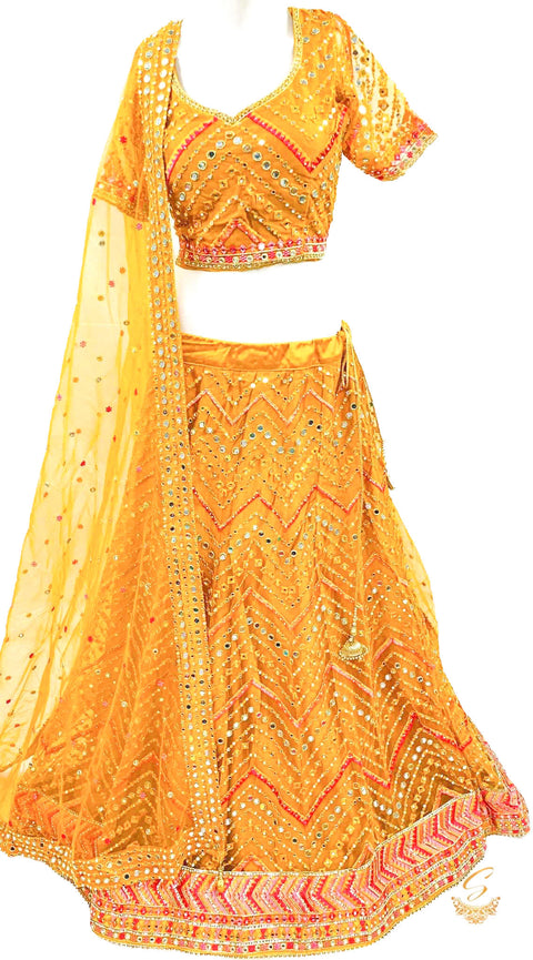 Deep Butterscotch Yellow colour netting based beautiful heavy embroidered work heavy ken ken big flare stitched Lehnga & Blouse with attached Tessels & heavy lace border beaded work DupattaSize 40 (UPTO 44)