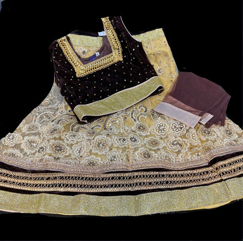 Dark brown colour velvet blouse with stone work ,netting golden colour lehnga & netting dupatta