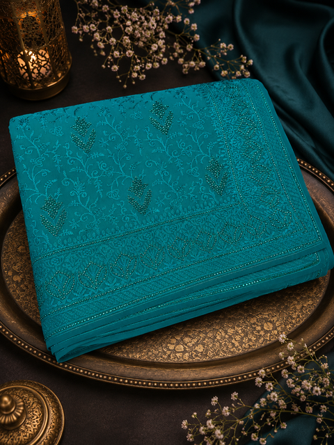 Beautiful Shimmery Georgette Saree featuring elegant embroidery and stone work throughout. Comes with an unstitched matching blouse piece. Model blouse is for reference purpose only. Slight colour and design variations may occur.