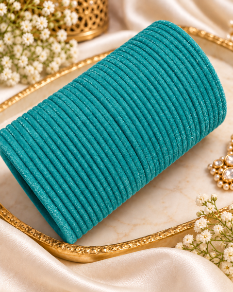 Elegant velvet bangles in a rich Turquoise Blue shade, perfect for festive, bridal and traditional looks. Each pack includes 3 dozen bangles (36 pieces). Price is per pack. Slight variation in colour may be possible