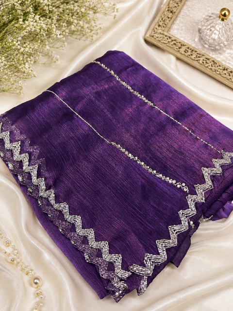 Elegant Jimmy Choo Saree featuring intricate handwork detailing and a beautifully embellished border. Comes with an attached matching blouse piece, blouse worn by the model is for reference purposes only(slight variation in color and design is possible)