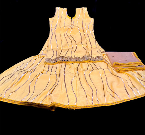 Yellow colour silk based kids sharara suit with golden dupatta