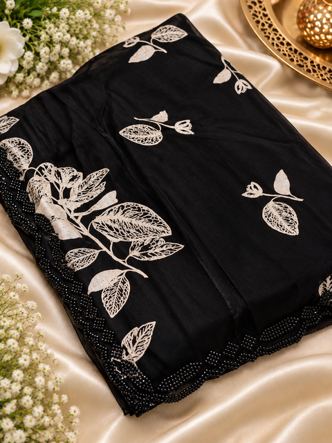 Fendi Silk Saree – Elegant floral print with beautiful black stone handwork border all around. Soft, stylish, two toned shiny. Matching blouse piece attached; model blouse is for reference only. Slight variation in colour/design is possible.