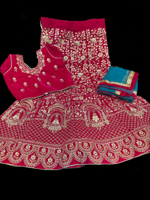 Deep Mazenta colour velvet based heavy embroidery lehnga with teal colour netting embroidered dupatta