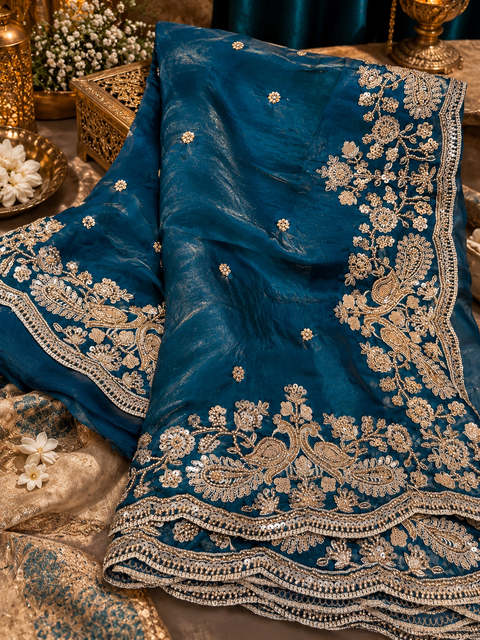 Teal Peacock Fendi Silk Saree with a beautiful natural shine, finished with a heavy floral handwork border with sequin and zari detailing and delicate motifs all over and on blouse.model blouse is for reference.Slight variation in color & design may occur