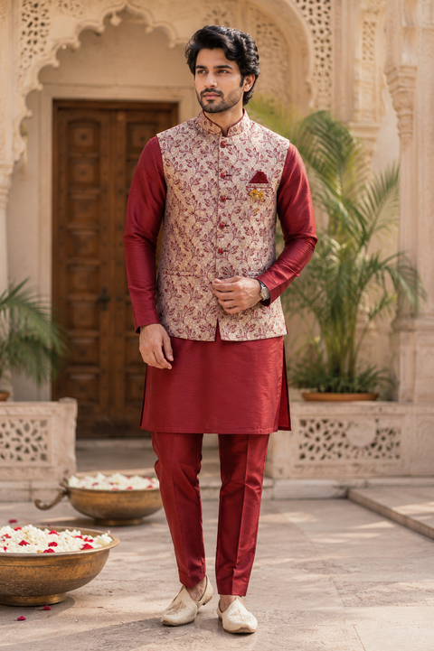 Elegant Maroon kurta set with a premium textured jacket, detailed gold accents, and a refined festive look. Slight variation in color and design may occur.