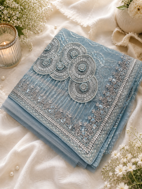 Heavy work designer Saree with netting base fabric and stones work design all over with heavy embroidery .The Blouse Worn By The Model Is For Reference Purposes Only. The Actual Blouse Piece Comes Attached With Saree(Slight Variations Are Possible)