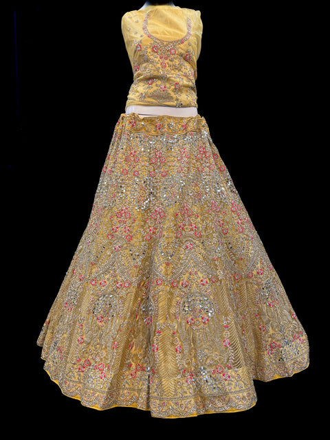 (Video clip attached)Gold colour netting Based Beautiful Embroidery & Mirror Work With Golden Fine Stones& beaded work Very Heavy Layered Designer semi/Bridal Lehnga With Heavy Tessels Attached To Blouse & Lehnga