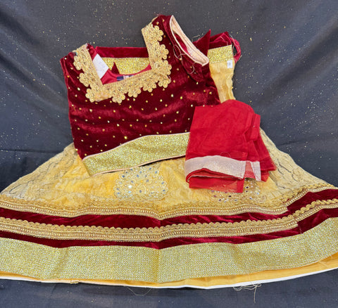 Maroon colour velvet blouse with stone work ,netting golden colour lehnga & netting dupatta
