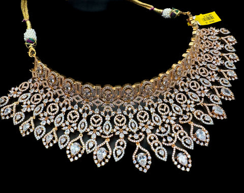 (video clip attached )Golden color Beautiful and elegant look Bridal/Semi Bridal American diamonds studded Heavy work necklace with beautiful earrings Note :- original AD stones  not fake plastic stones )
