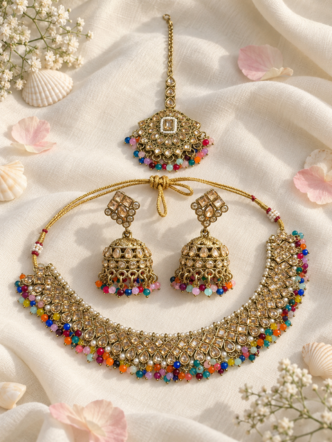 Elegant polki Necklace Set featuring beautiful Kundan stones, pearl detailing and bead drops. Comes with matching earrings and maang tikka. Slight variation in colour and design may be possible.