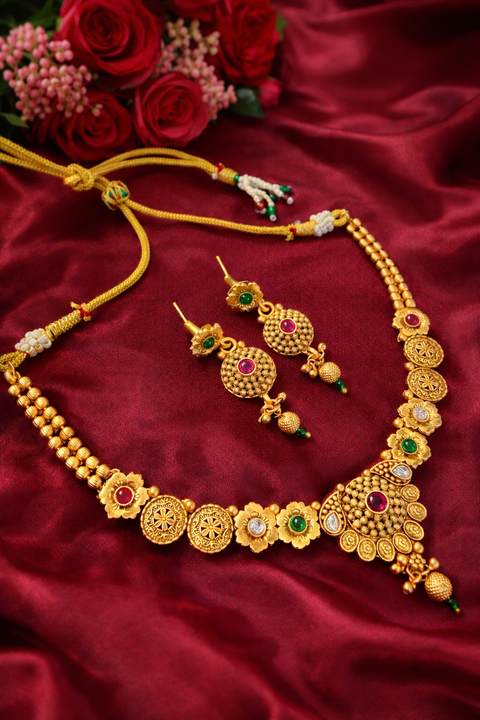 Elegant matte gold necklace set with intricate floral detailing and subtle stone accents, perfect for a timeless festive look