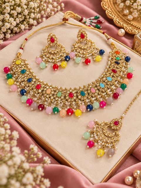 Beautiful polki stones with pearls and colorful stones necklace & earrings with Tikka. Slight variations in colour and design are possible