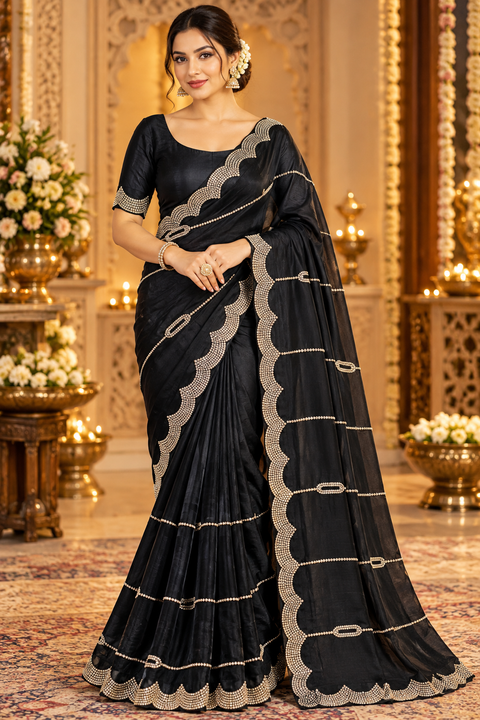 Soft Shiny Georgette Saree with a beautiful flowy drape, elegant stonework lines and a rich scalloped stone border. Attached blouse piece included; model blouse is for reference only. Slight variation in colour and design is possible.