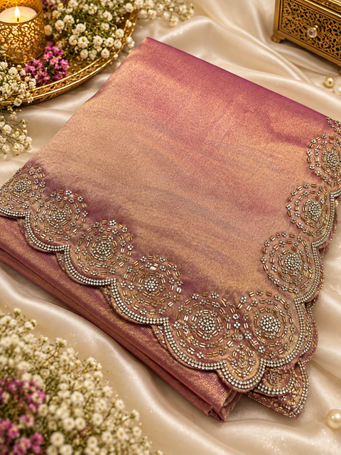 Two-Tone Tissue Silk Saree with a beautiful gold sheen and elegant handcrafted border detailing. Comes with an attached blouse piece; blouse worn by the model is for reference only. Slight variation in colour and design is possible.