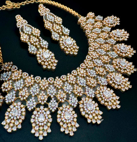 (video clip attached )Golden color Beautiful and elegant look Bridal/Semi Bridal American diamonds studded Heavy work necklace with beautiful earrings Note :- original AD stones  not fake plastic stones )