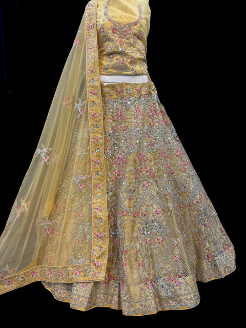 (Video clip attached)Gold colour netting Based Beautiful Embroidery & Mirror Work With Golden Fine Stones& beaded work Very Heavy Layered Designer semi/Bridal Lehnga With Heavy Tessels Attached To Blouse & Lehnga