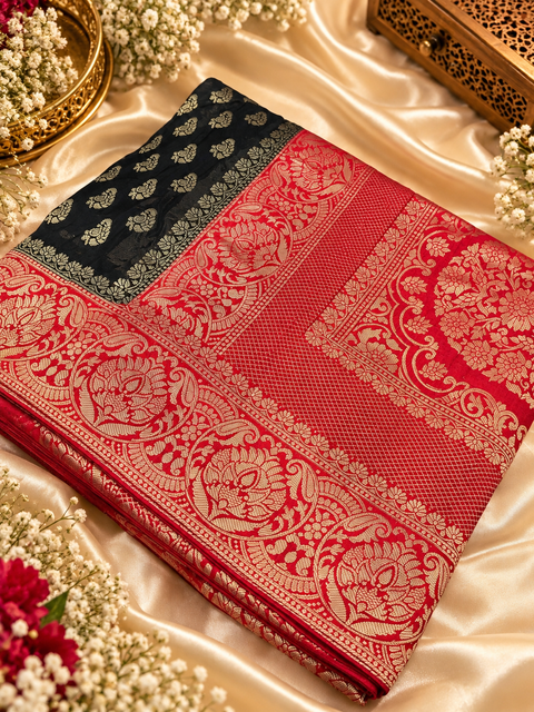 Dola Silk Saree with elegant all-over floral zari weaving and a rich contrasting woven border with detailed pallu. Soft, graceful drape with a luxurious festive look. Contrast blouse piece included.Slight variation in colour and design is possible.