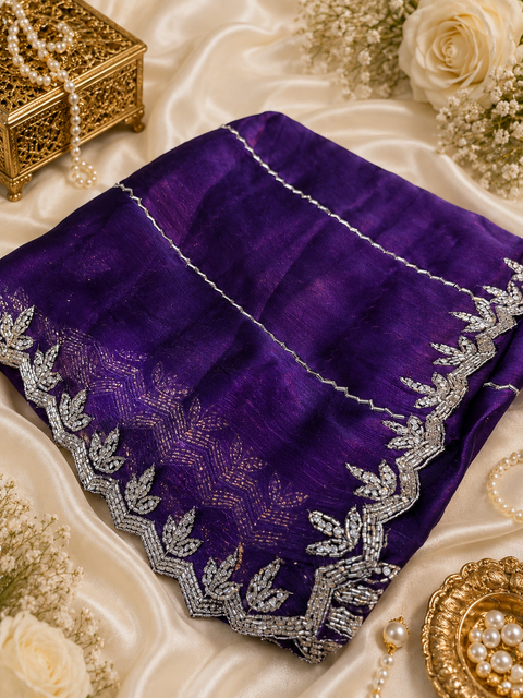 Elegant Jimmy Choo Saree featuring intricate handwork detailing and a beautifully embellished border. Comes with an attached matching blouse piece, blouse worn by the model is for reference purposes only(slight variation in color and design is possible)