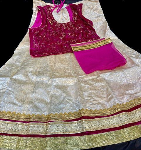 velvet based stone work blouse with golden with pink and red shades on raw silk based lehnga