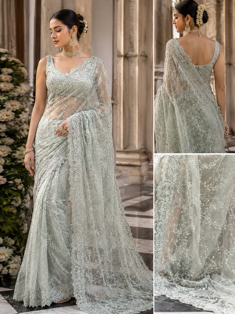 Pastel Mint Color Heavy Work Designer Saree With Netting Base Fabric And Stones Work Design All Over With Embroidery . The Blouse Worn By The Model Is For Reference Purposes Only.blouse Piece Comes Attached With Saree(Slight Variations Are Possible