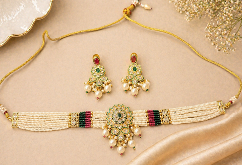 Elegant pearl choker set featuring intricate gold detailing and a statement original kundan-style centerpiece, paired with matching earrings for a timeless look.Perfect blend of tradition and sophistication