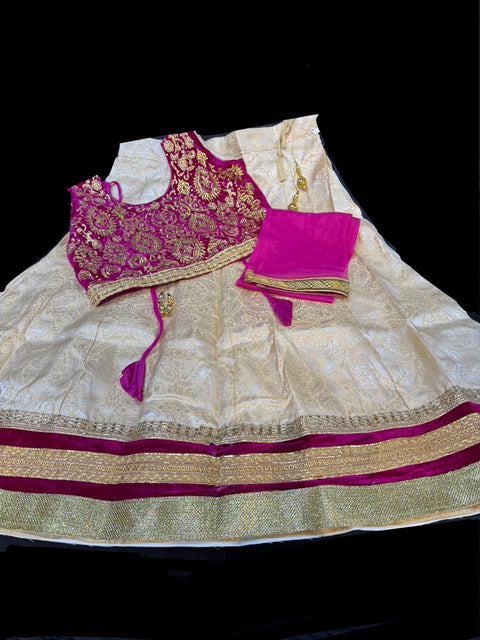 Dark Maroon colour velvet based blouse with embroidery & Stone work with golden brocade silk Lehnga & netting dupatta