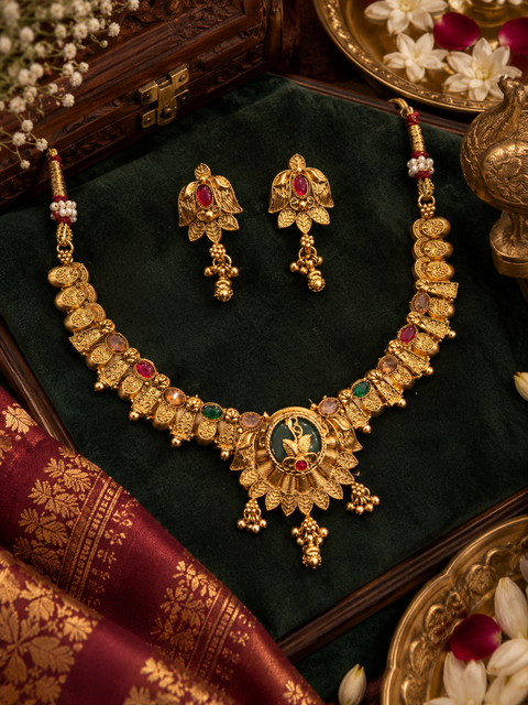 Elegant temple-style gold necklace set with intricate detailing, multicolour stones and pearl accents. Comes with matching jhumka earrings.(slight variation in color & design may occur)